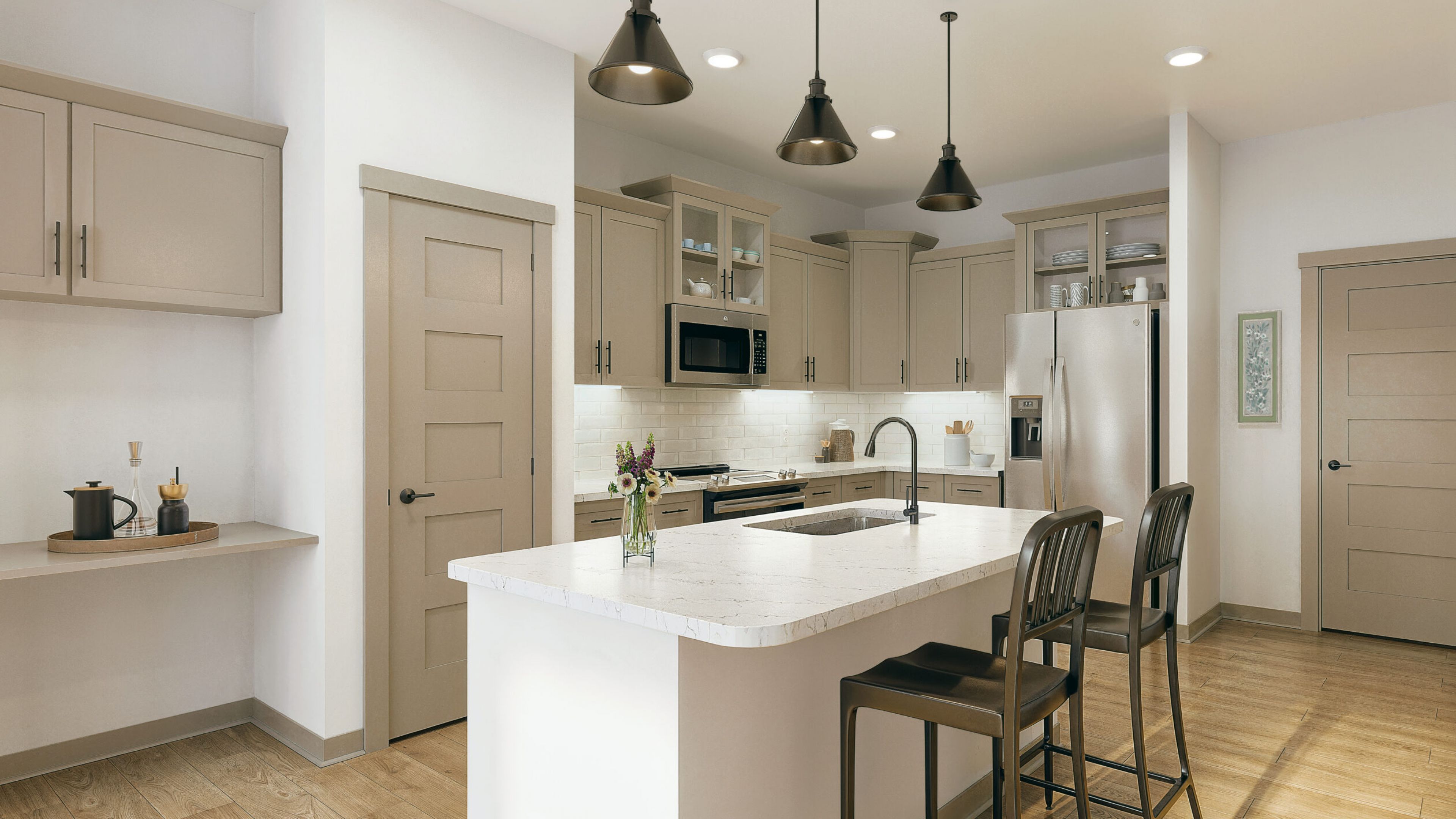 Hawthorne at Hixson apartment living space and kitchen with small dining table, kitchen peninsula, and stainless steel appliances